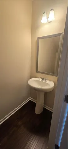 a bathroom with a sink toilet and a mirror