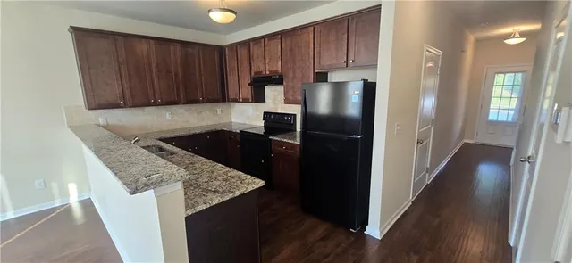 a kitchen with a refrigerator and a sink
