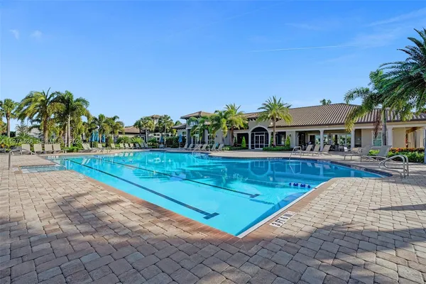 a view of swimming pool with outdoor seating and plants