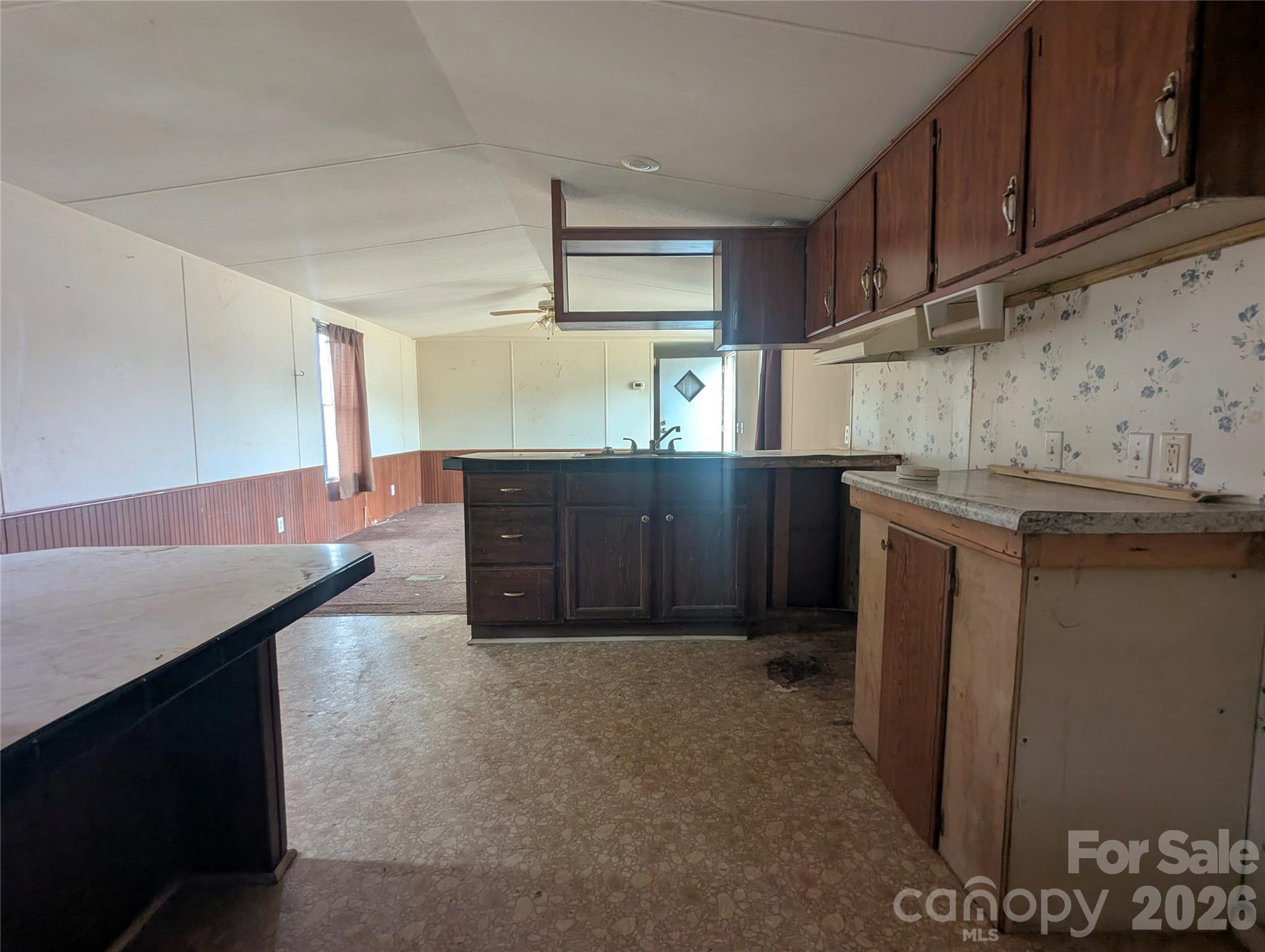 565 Jm Lovelace Road Ellenboro, NC 28040 - Photo 17 of 42 a kitchen with stainless steel appliances cabinets and wooden floor