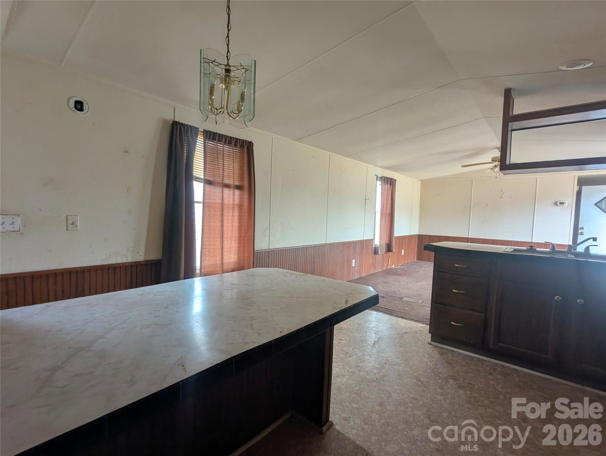 565 Jm Lovelace Road Ellenboro, NC 28040 - Photo 19 of 42 a kitchen with a wooden floor and large window