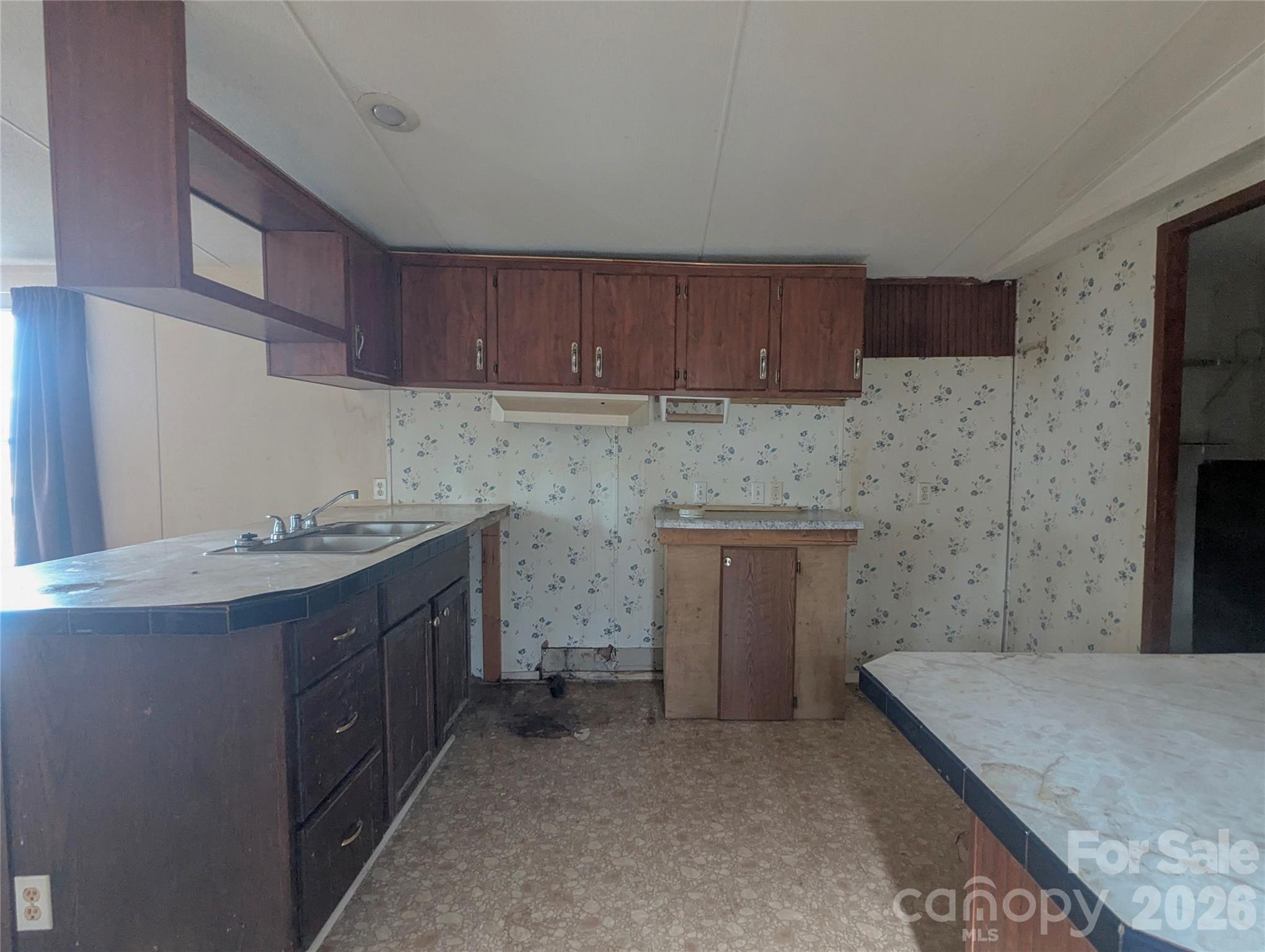 565 Jm Lovelace Road Ellenboro, NC 28040 - Photo 24 of 42 a kitchen with stainless steel appliances granite countertop a stove a sink and a refrigerator