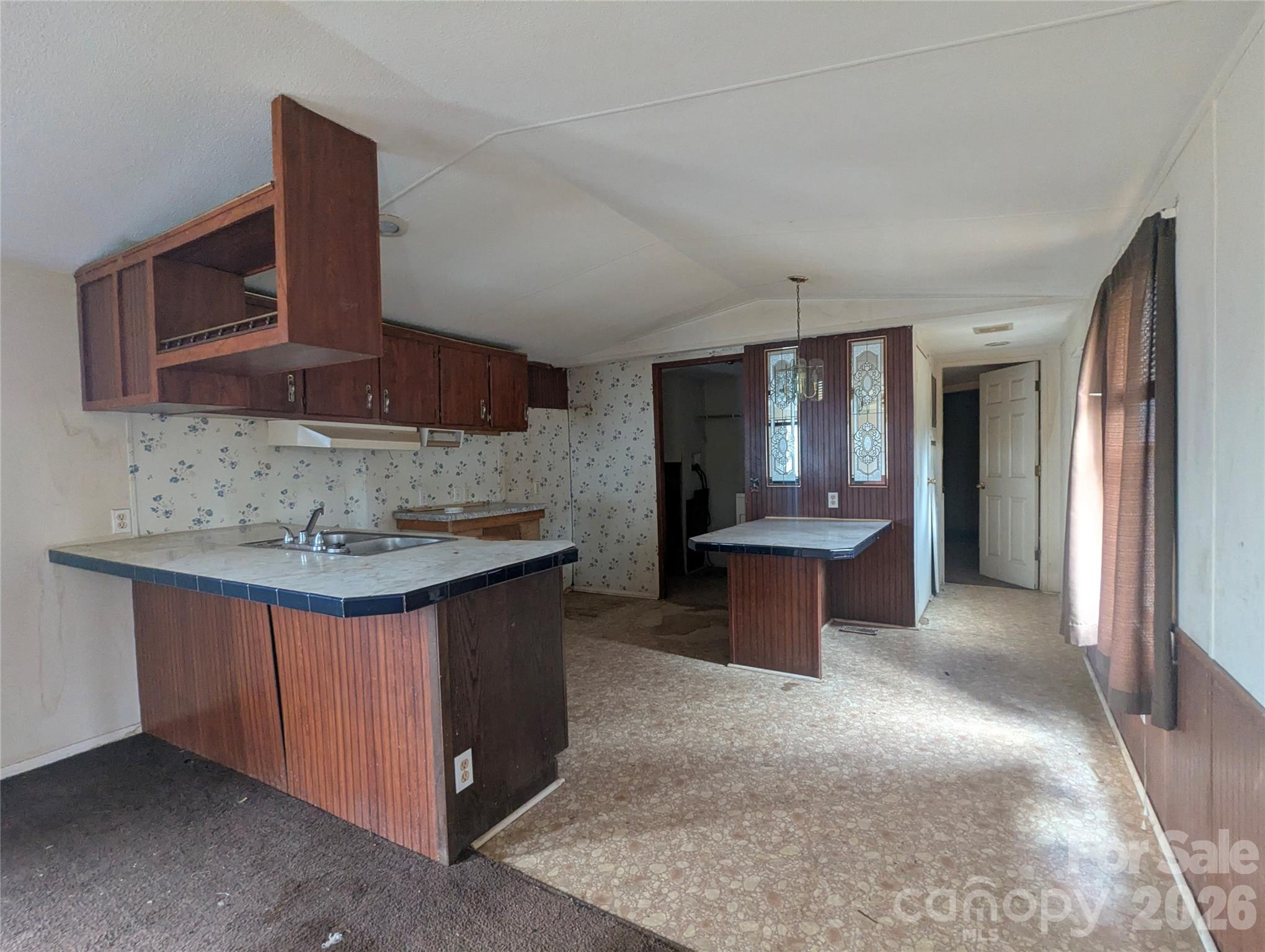 565 Jm Lovelace Road Ellenboro, NC 28040 - Photo 25 of 42 a kitchen with stainless steel appliances granite countertop a sink and a stove