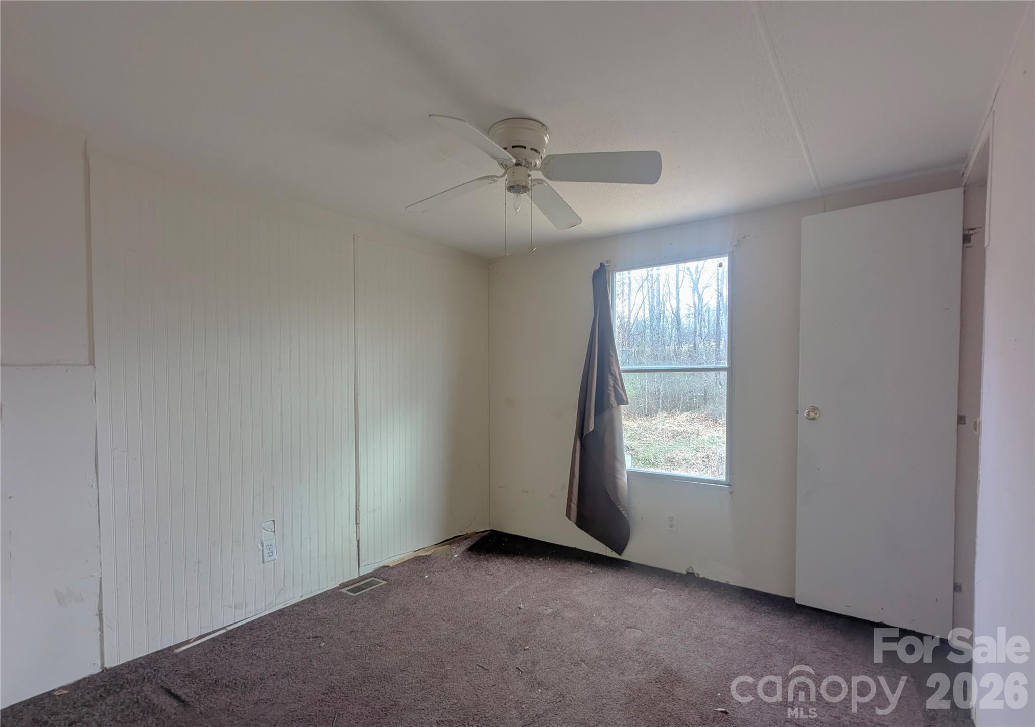 565 Jm Lovelace Road Ellenboro, NC 28040 - Photo 33 of 42 an empty room with windows and fan