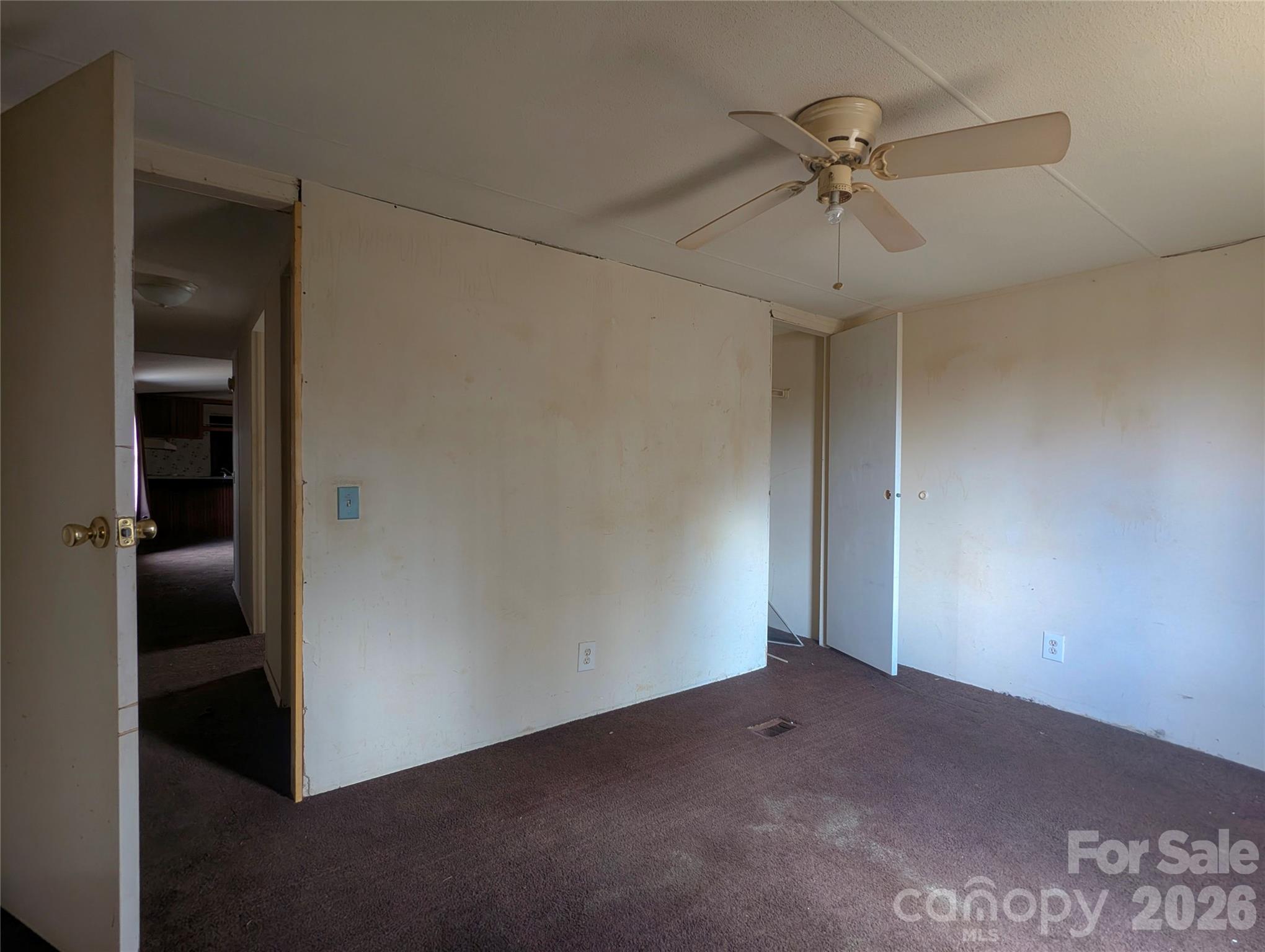 565 Jm Lovelace Road Ellenboro, NC 28040 - Photo 35 of 42 an empty room with a ceiling fan and a window