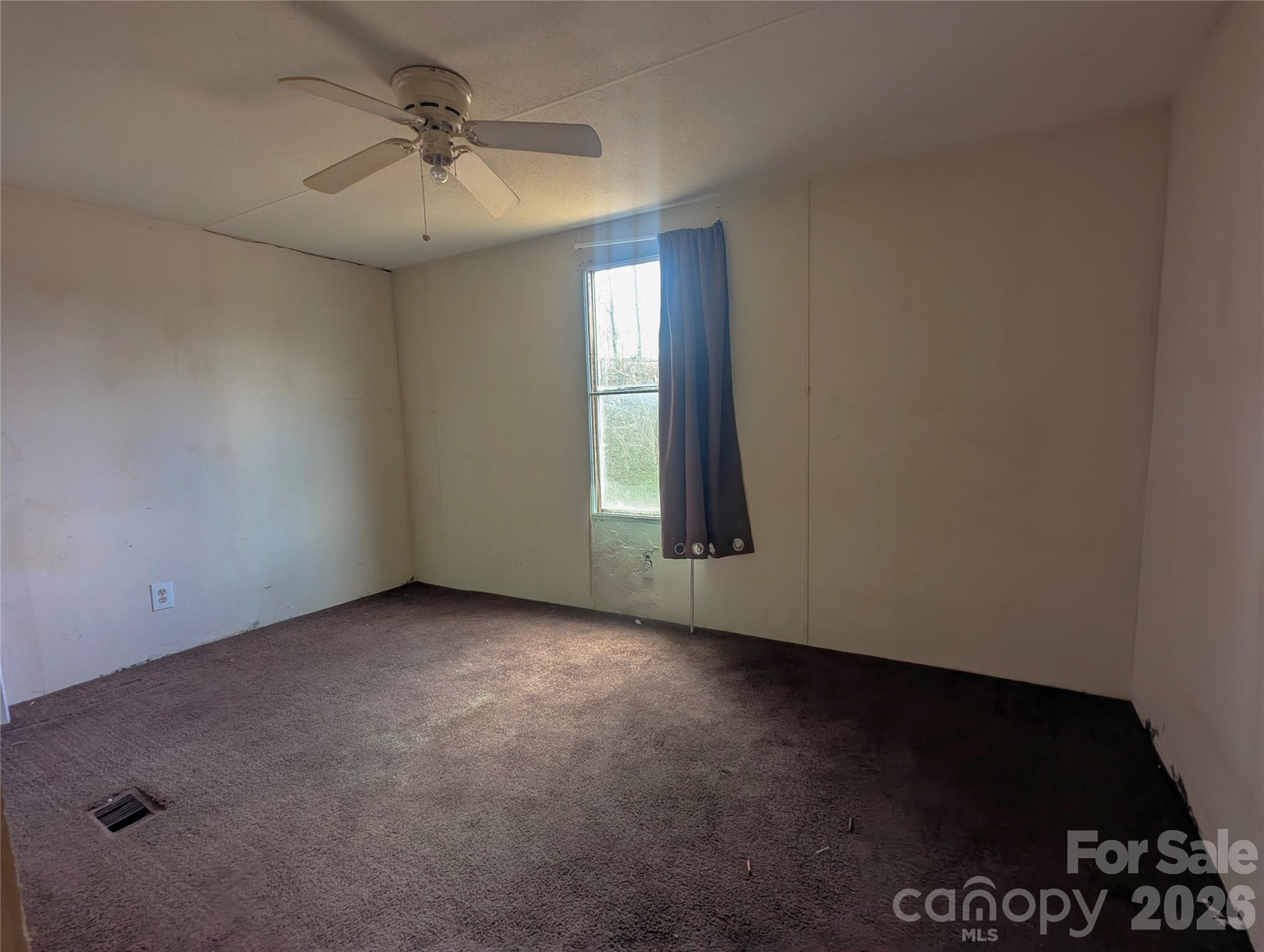 565 Jm Lovelace Road Ellenboro, NC 28040 - Photo 36 of 42 an empty room with windows and fan