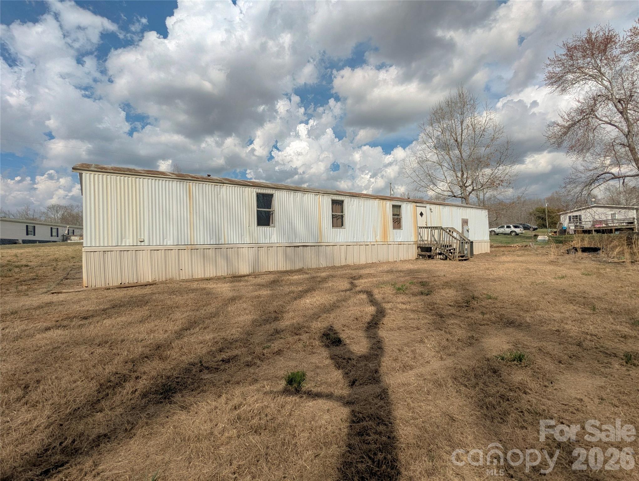 565 Jm Lovelace Road Ellenboro, NC 28040 - Photo 40 of 42 a view of a dry yard with wooden fence