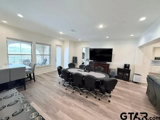 a living room with furniture flat screen tv and a large window