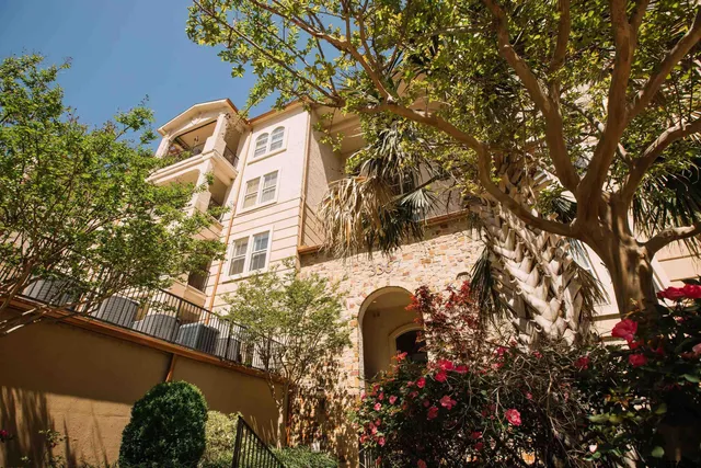 a front view of a building with a tree