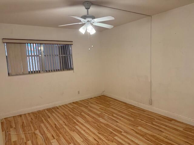 349 Flanders South Delray Beach, FL 33484 - Photo 11 of 26 an empty room with wooden floor fan and windows