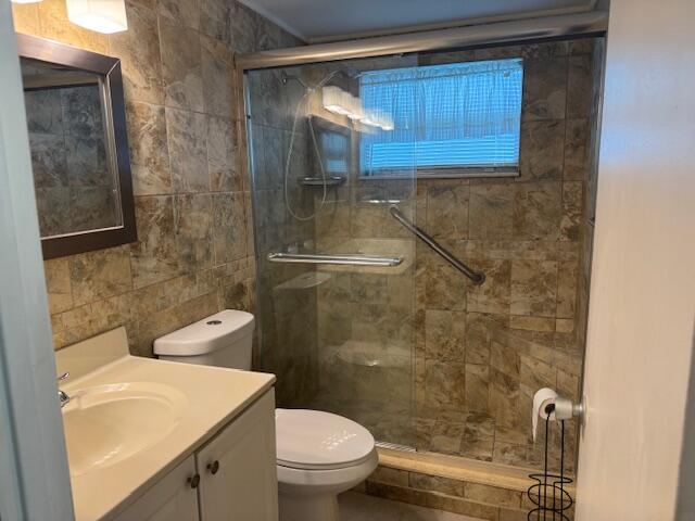 349 Flanders South Delray Beach, FL 33484 - Photo 14 of 26 a bathroom with a sink a toilet and shower