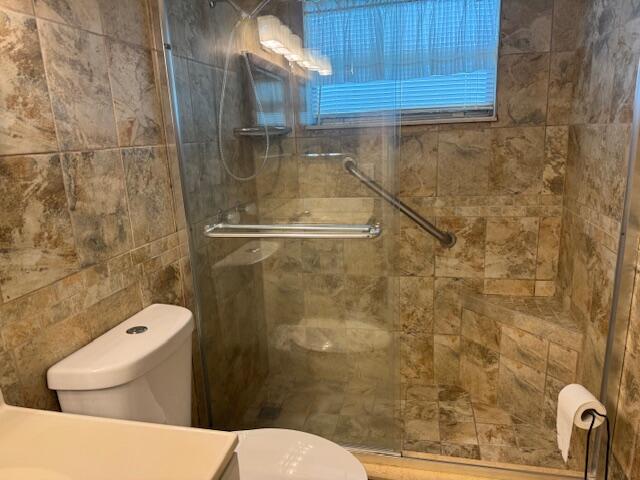 349 Flanders South Delray Beach, FL 33484 - Photo 15 of 26 a bathroom with a toilet and a shower