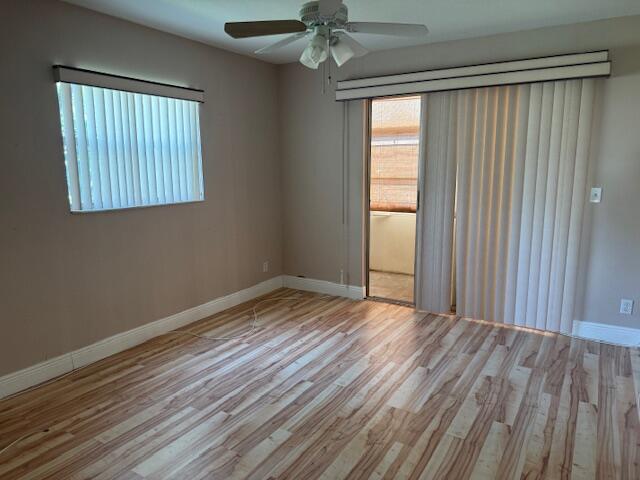 349 Flanders South Delray Beach, FL 33484 - Photo 17 of 26 an empty room with wooden floor chandelier fan and windows