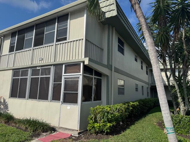 349 Flanders South Delray Beach, FL 33484 - Photo 25 of 26 a front view of a house with a garden