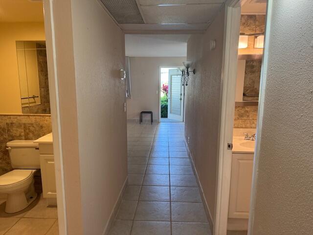 349 Flanders South Delray Beach, FL 33484 - Photo 10 of 26 a hallway with wooden floor a bathroom