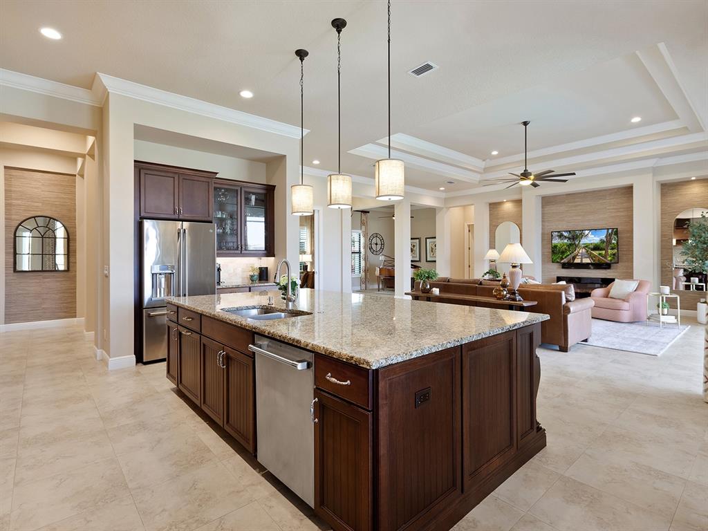 11708 Rive Isle Run Parrish, FL 34219 - Photo 13 of 65 a kitchen with kitchen island a sink and a refrigerator
