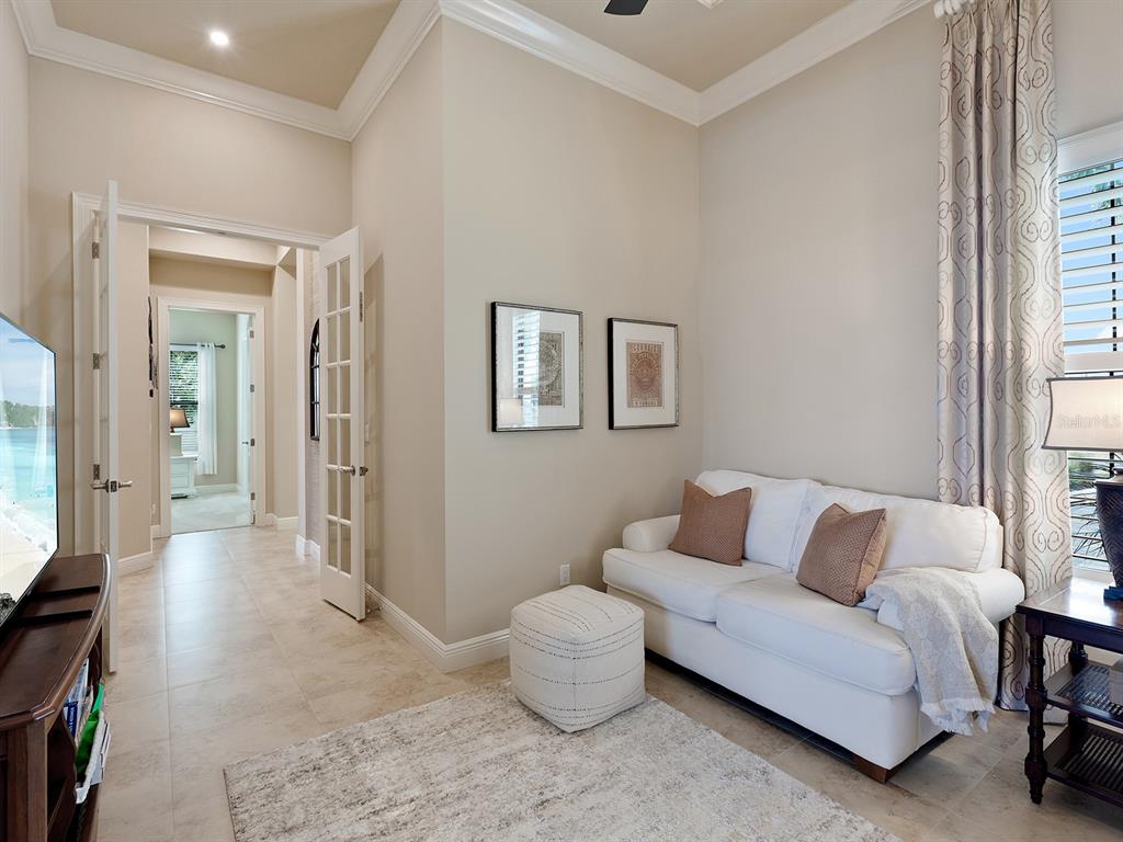 11708 Rive Isle Run Parrish, FL 34219 - Photo 19 of 65 a living room with furniture and a window