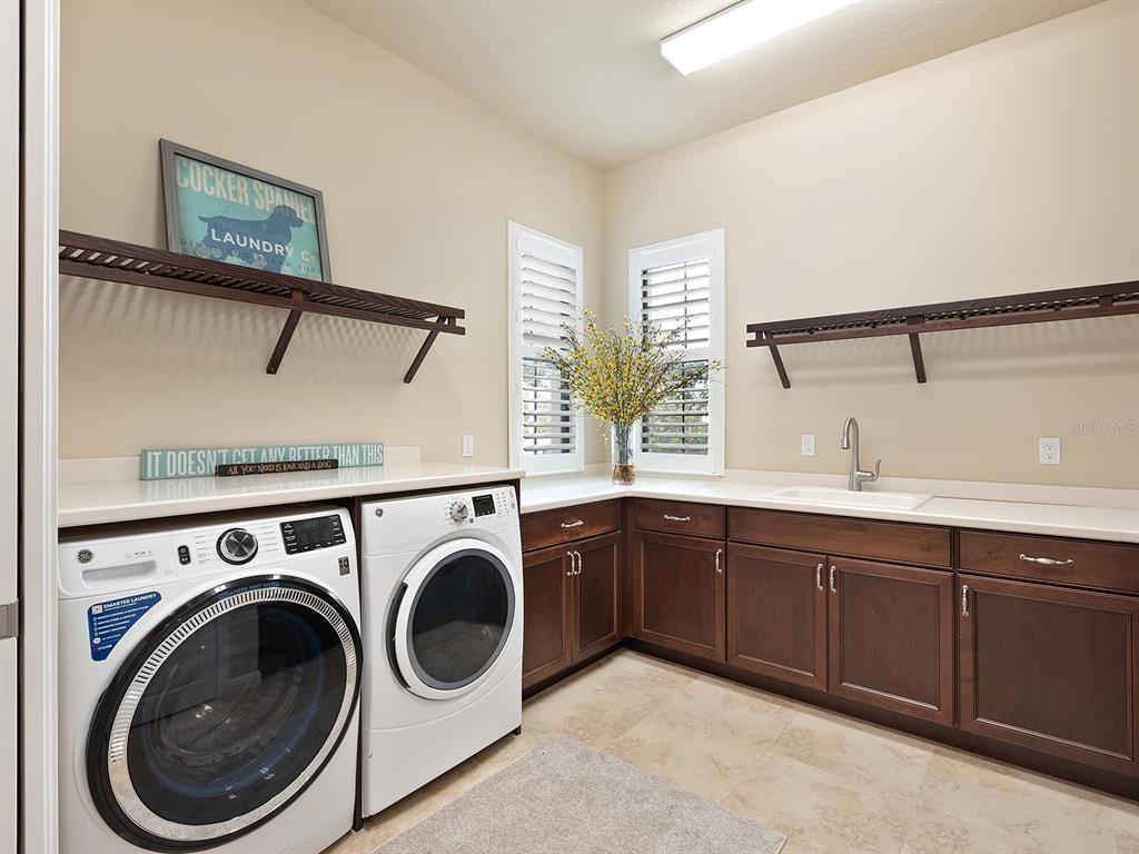 11708 Rive Isle Run Parrish, FL 34219 - Photo 23 of 65 a utility room with sink dryer and washer
