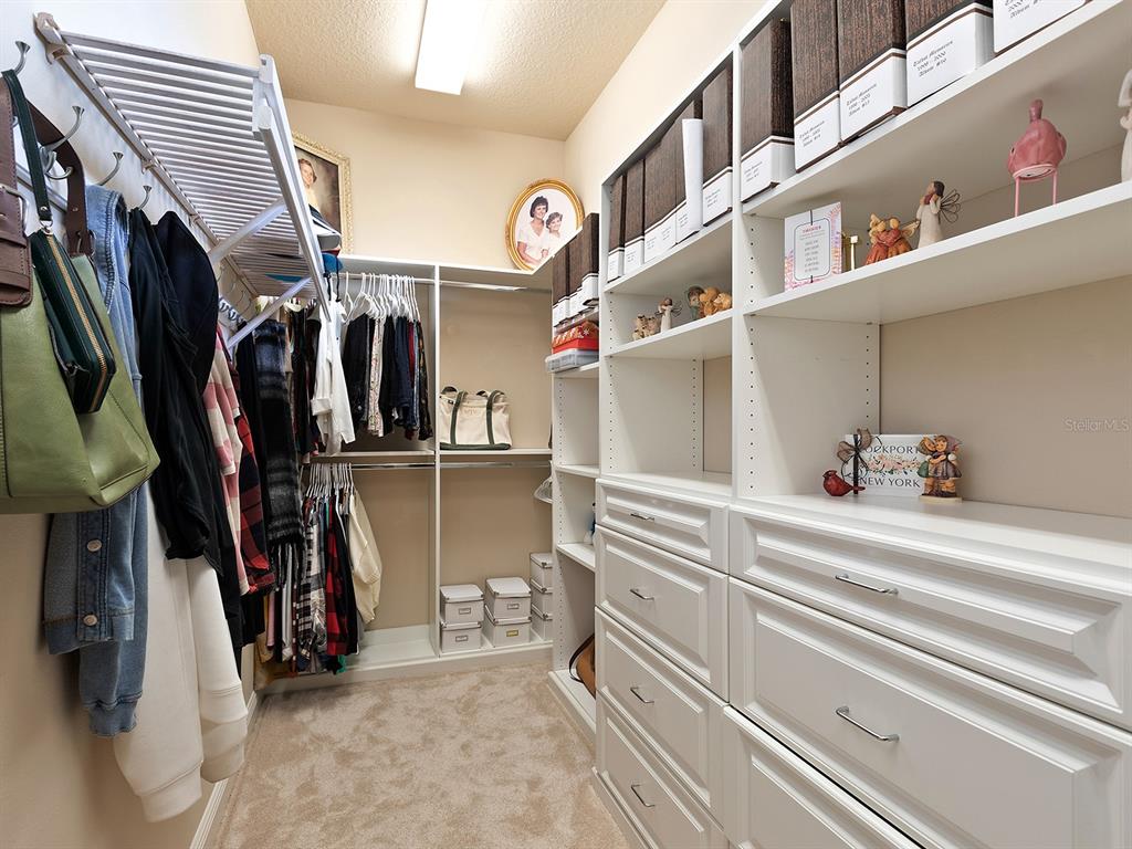 11708 Rive Isle Run Parrish, FL 34219 - Photo 28 of 65 a view of walk in closet with clothes and shoes