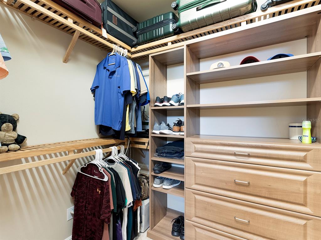 11708 Rive Isle Run Parrish, FL 34219 - Photo 29 of 65 a view of walk in closet with clothes and shoes