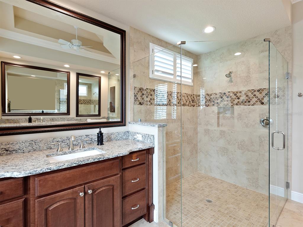 11708 Rive Isle Run Parrish, FL 34219 - Photo 32 of 65 a bathroom with a granite countertop sink mirror and double