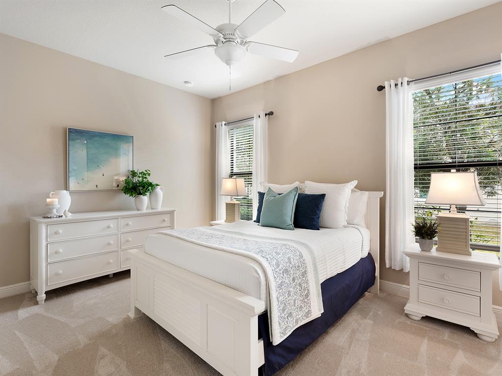 11708 Rive Isle Run Parrish, FL 34219 - Photo 33 of 65 a room with a bed and a dresser