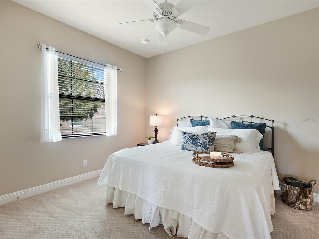 11708 Rive Isle Run Parrish, FL 34219 - Photo 36 of 65 a bedroom with a bed and a window