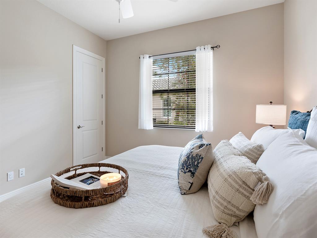 11708 Rive Isle Run Parrish, FL 34219 - Photo 37 of 65 a bedroom with a bed and a window