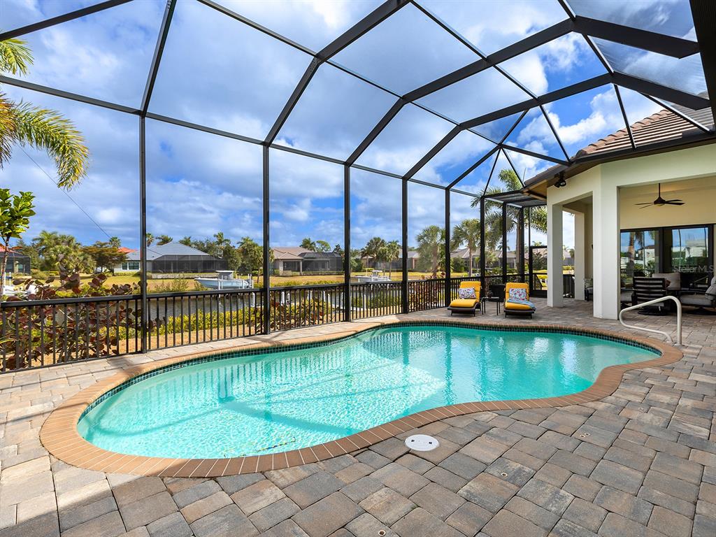 11708 Rive Isle Run Parrish, FL 34219 - Photo 40 of 65 a view of a swimming pool with a lounge chairs