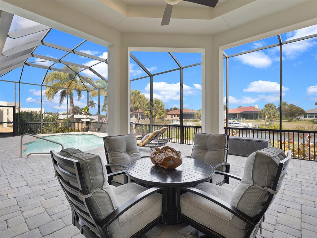 11708 Rive Isle Run Parrish, FL 34219 - Photo 43 of 65 a dining room with furniture and a floor to ceiling window