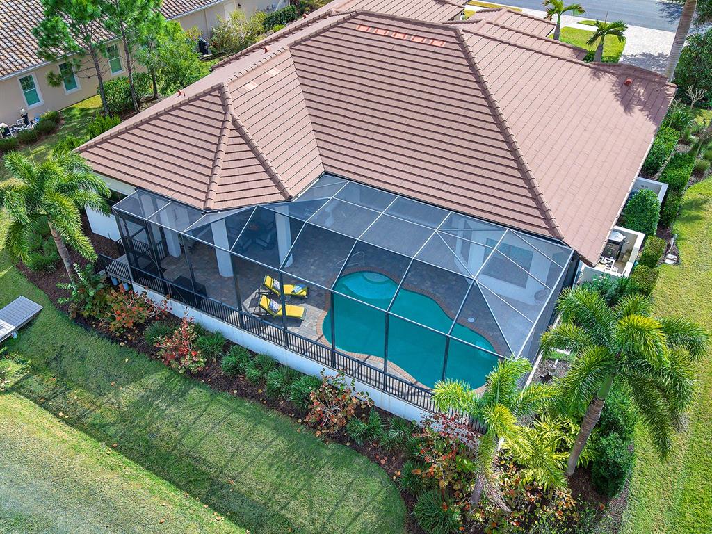 11708 Rive Isle Run Parrish, FL 34219 - Photo 44 of 65 a view of a white house with a yard and potted plants