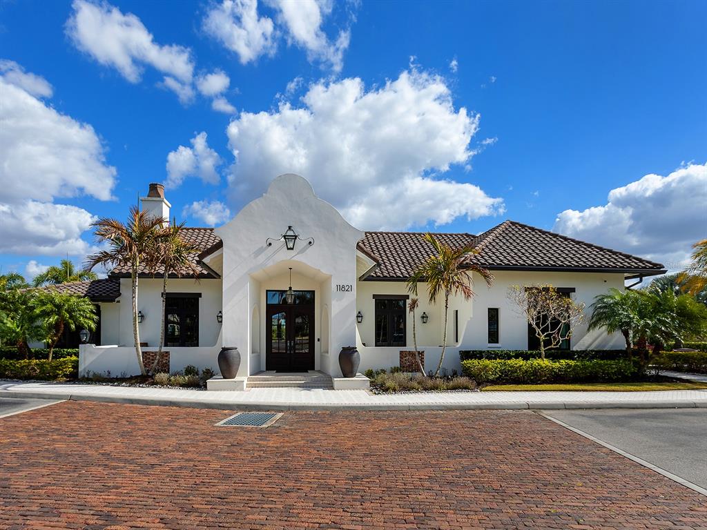 11708 Rive Isle Run Parrish, FL 34219 - Photo 49 of 65 a front view of a house with a yard and garage
