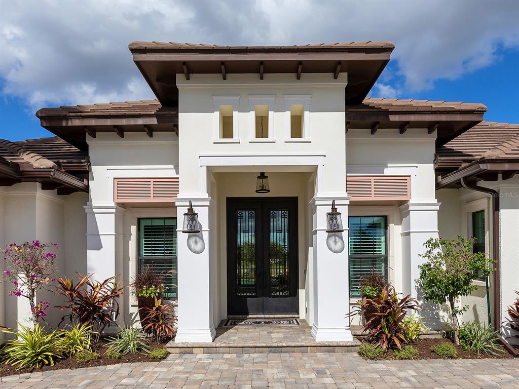11708 Rive Isle Run Parrish, FL 34219 - Photo 5 of 65 a front view of a house with glass windows