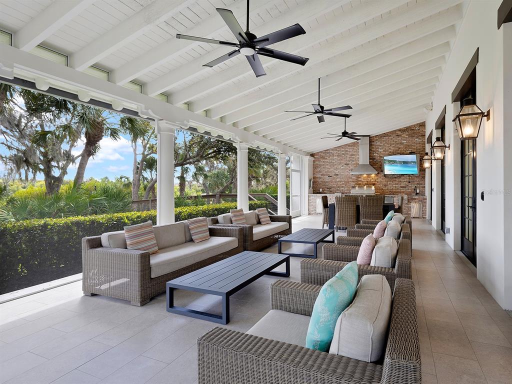 11708 Rive Isle Run Parrish, FL 34219 - Photo 51 of 65 a living room with patio furniture and a fireplace