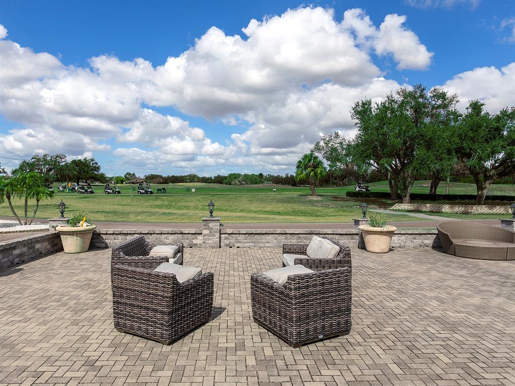 11708 Rive Isle Run Parrish, FL 34219 - Photo 59 of 65 a view of a patio with couches chairs and a fire pit