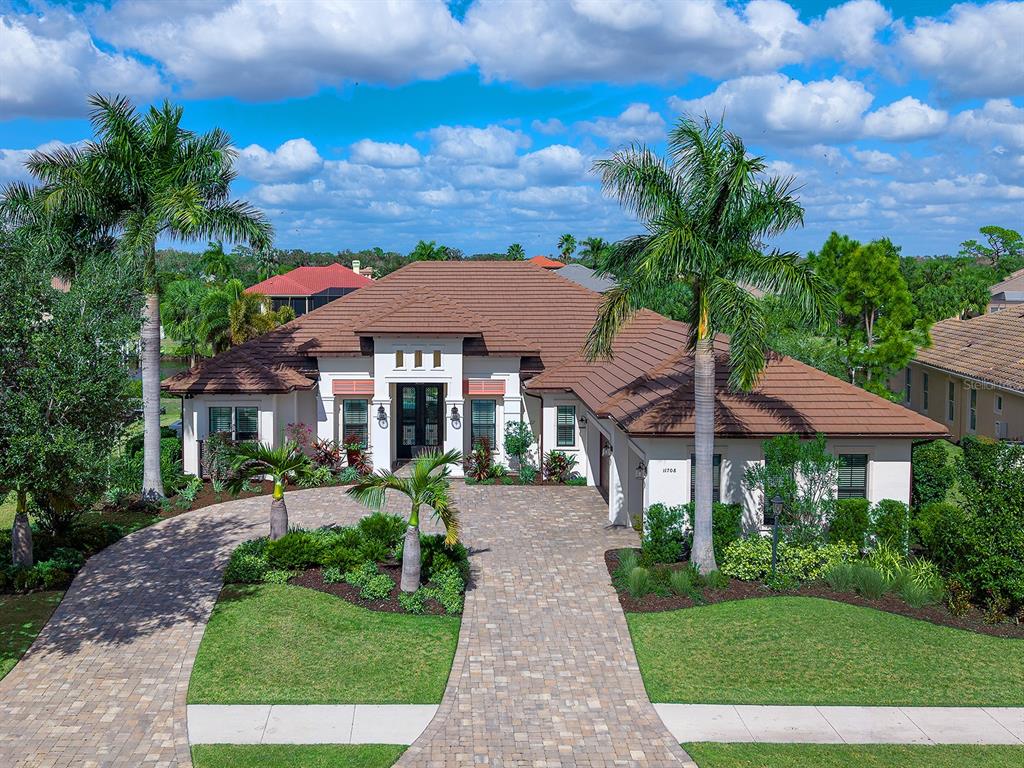 11708 Rive Isle Run Parrish, FL 34219 - Photo 65 of 65 a front view of a house with garden
