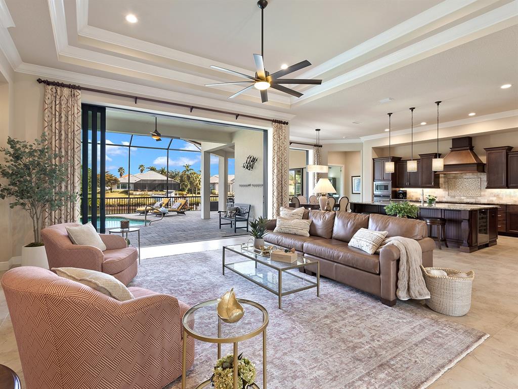 11708 Rive Isle Run Parrish, FL 34219 - Photo 8 of 65 a living room with furniture kitchen view and a chandelier