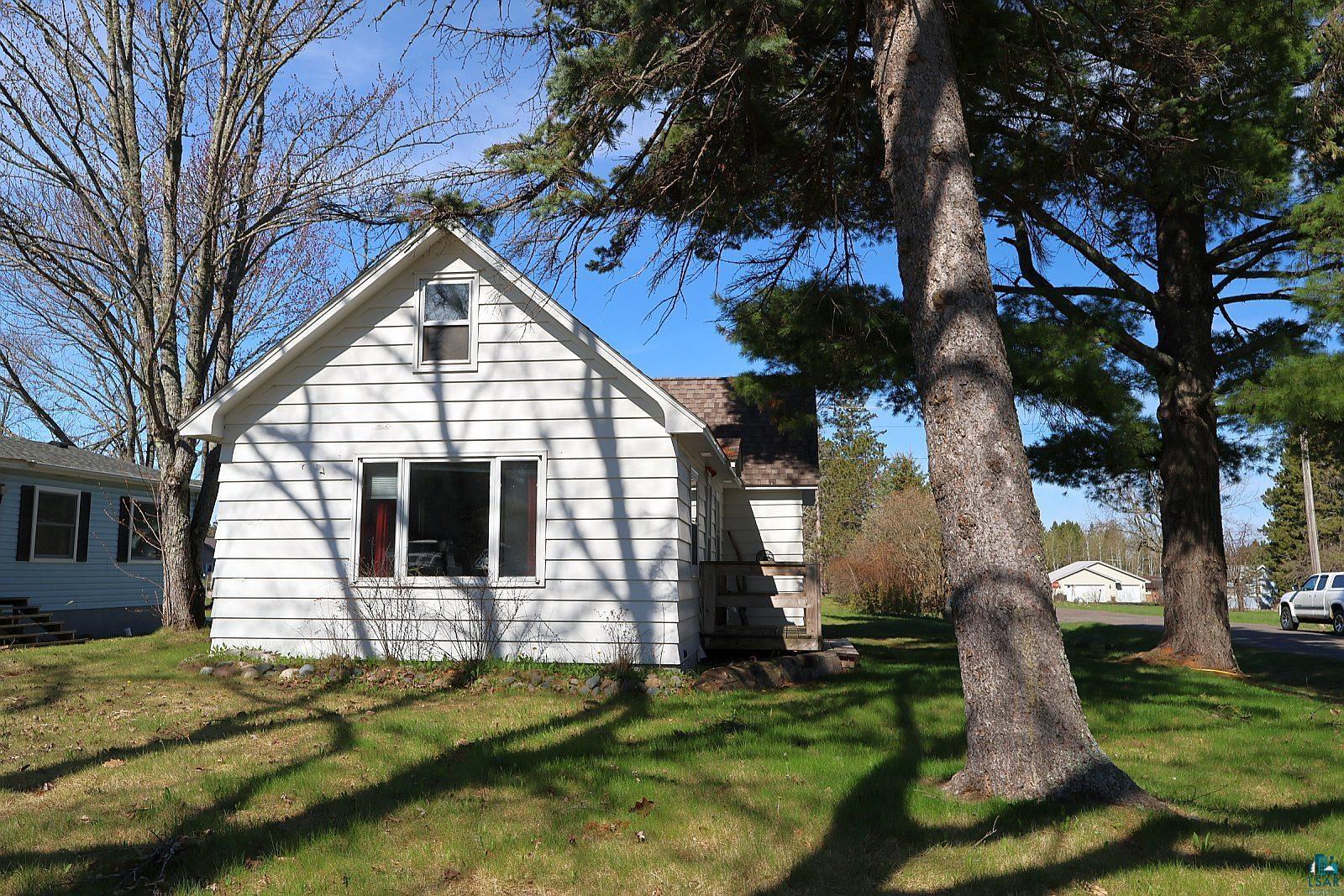 83185 Washington Avenue Port Wing, WI 54865 - Photo 24 of 26 White siding exterior with a prominent front-facing gable and multiple windows