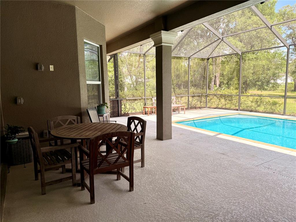 13110 Bamboo Street Spring Hill, FL 34609 - Photo 42 of 56 a view of a dining room with furniture window and outside view