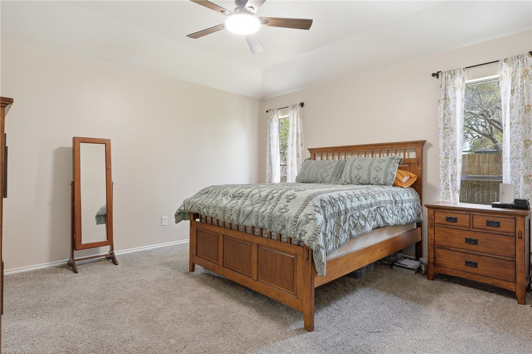 2169 Timberleaf Circle Ingleside, TX 78362 - Photo 16 of 36 a bedroom with a bed and a chandelier