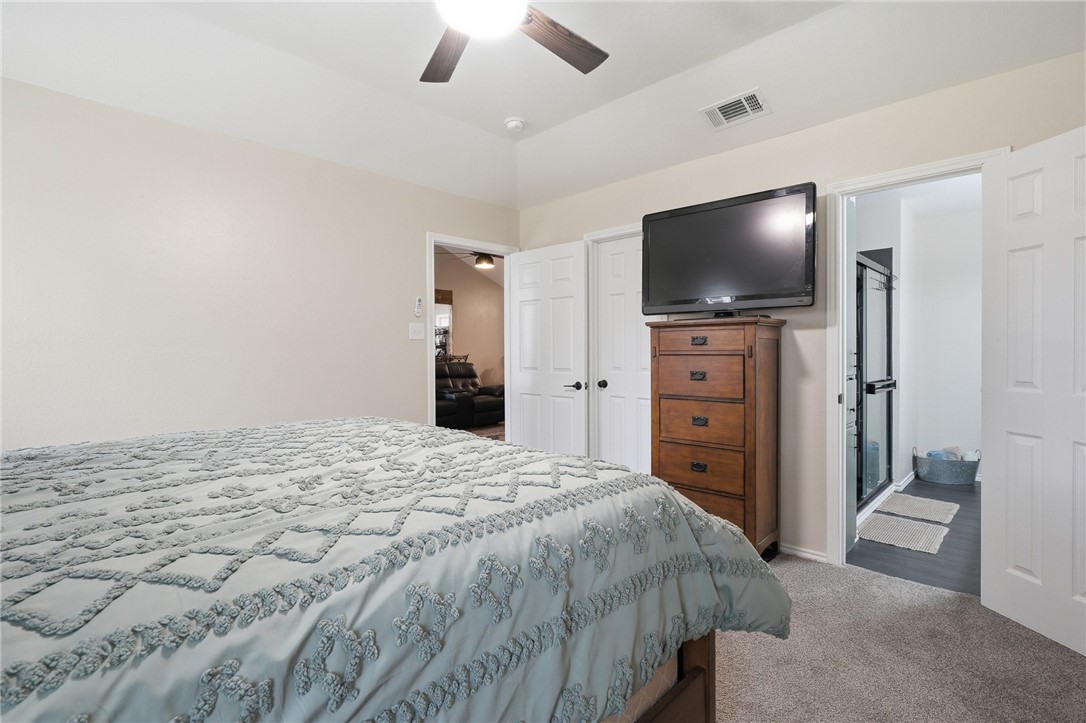 2169 Timberleaf Circle Ingleside, TX 78362 - Photo 17 of 36 a bedroom with a bed and a flat screen tv