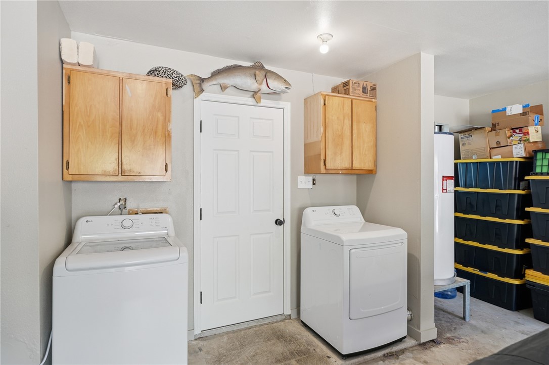 2169 Timberleaf Circle Ingleside, TX 78362 - Photo 24 of 36 a bathroom with a sink a washer and dryer