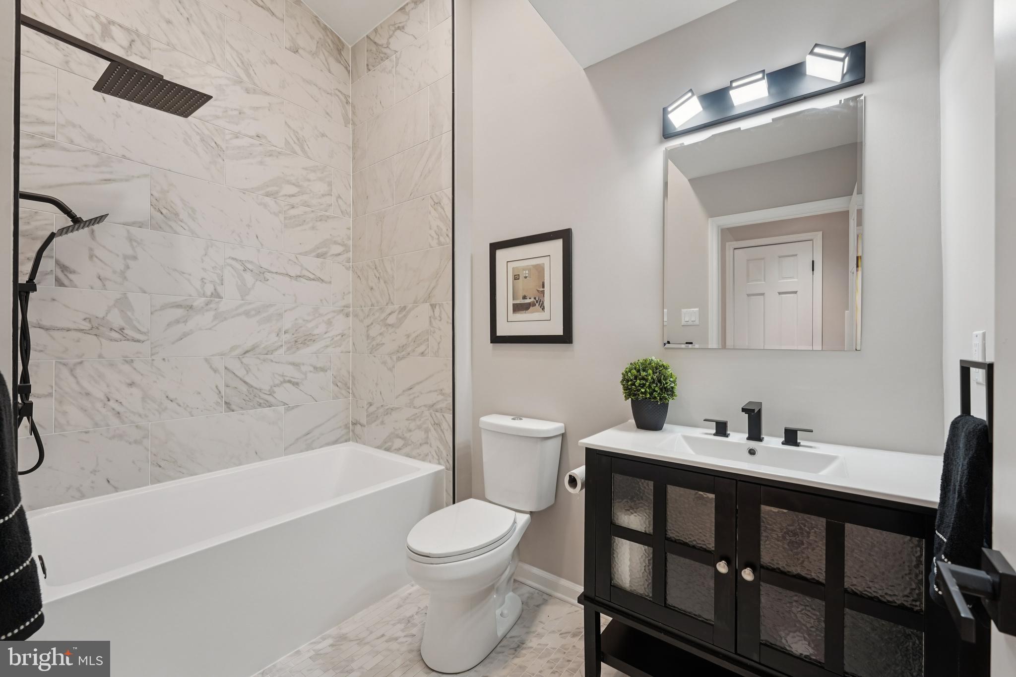 2839 Garwood Road Sicklerville, NJ 08081 - Photo 14 of 23 a bathroom with a bathtub shower sink vanity mirror and toilet