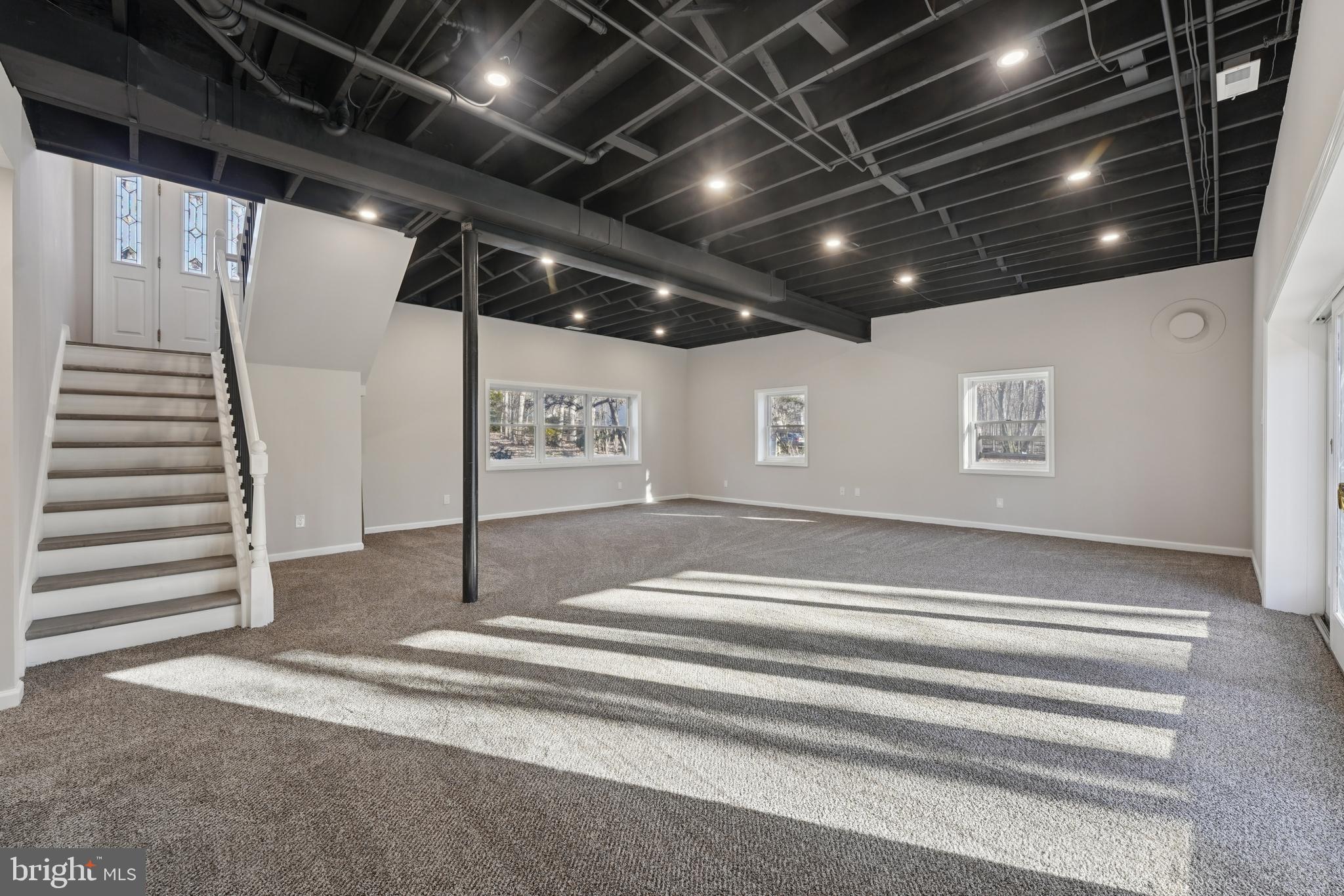 2839 Garwood Road Sicklerville, NJ 08081 - Photo 15 of 23 a view of an empty room with stairs and a projector