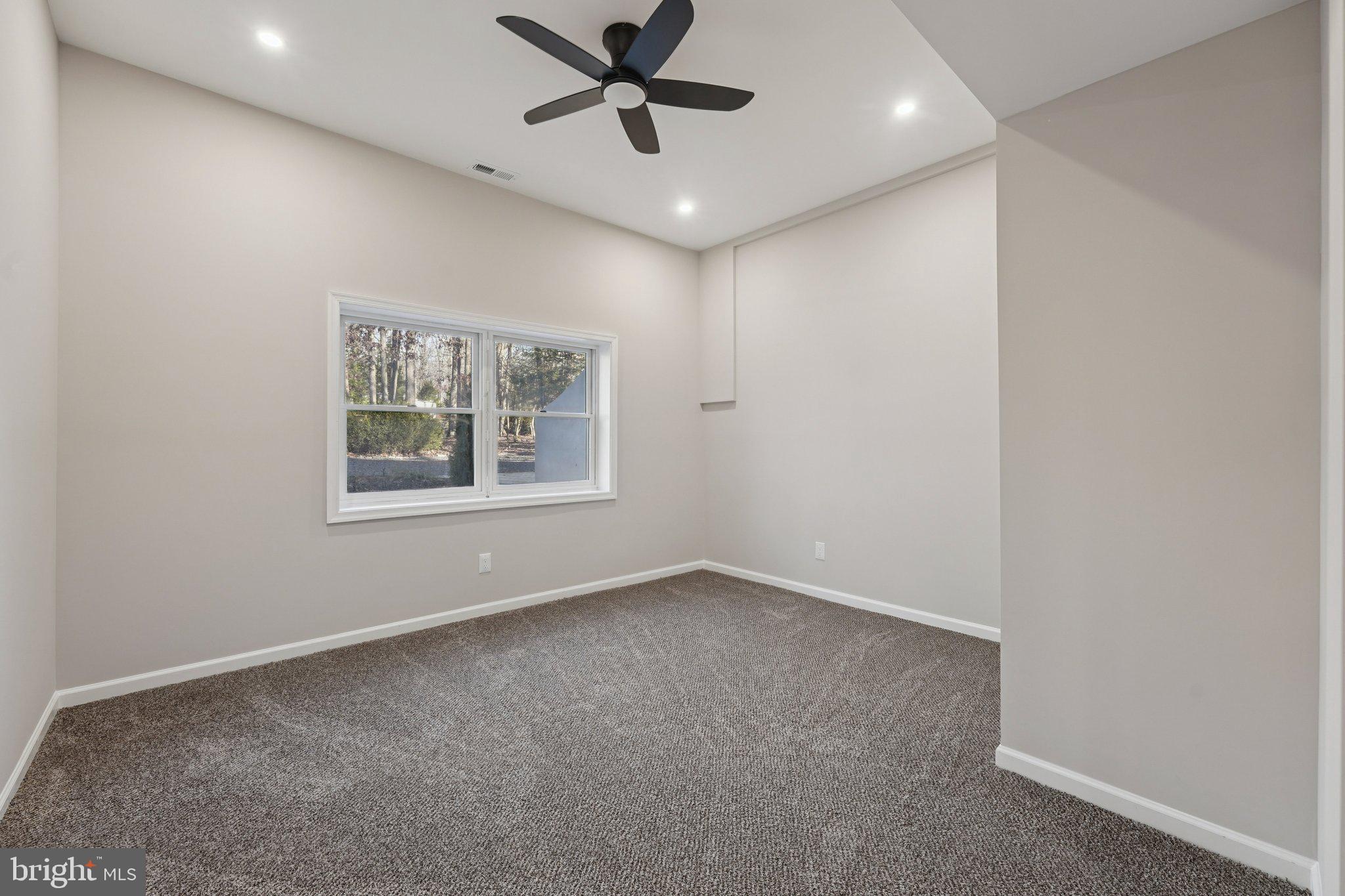 2839 Garwood Road Sicklerville, NJ 08081 - Photo 22 of 23 en empty room with windows and ceiling fan