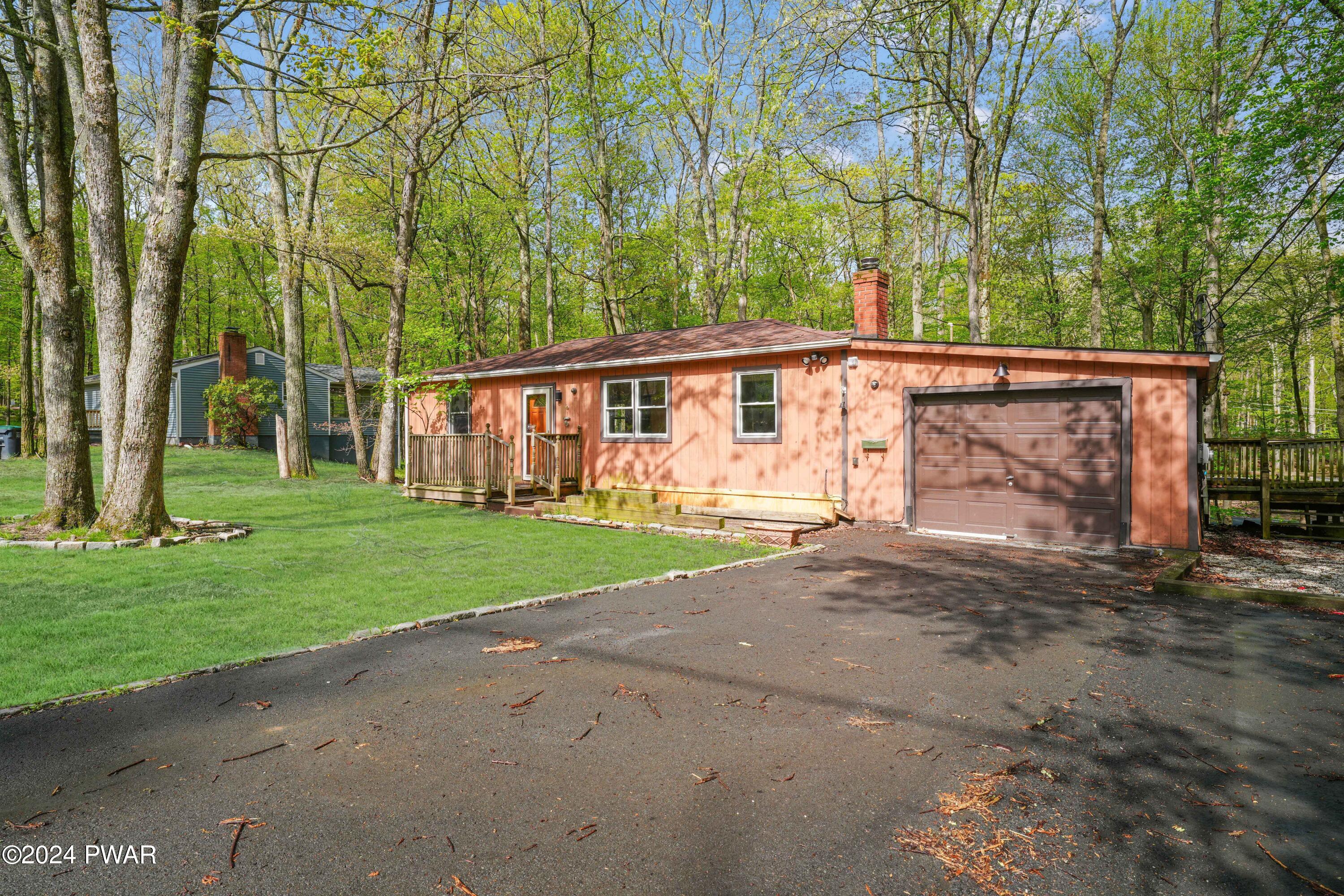 127 Slaymaker Road Milford, PA 18337 - Photo 3 of 22 a view of a house with a yard and garage