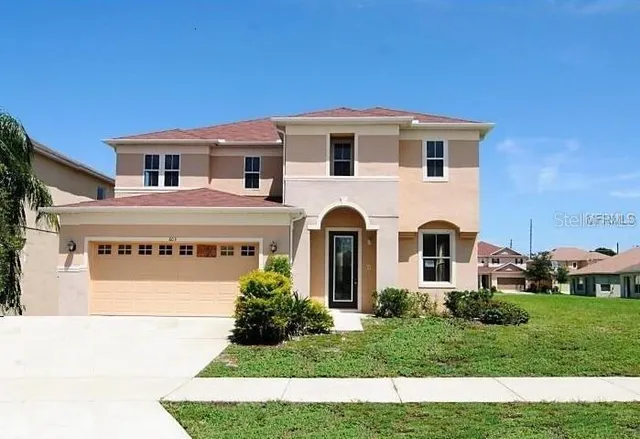 a view of a white house with a yard