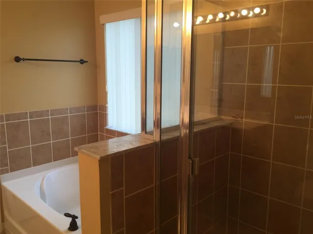 a bathroom with a shower and a sink