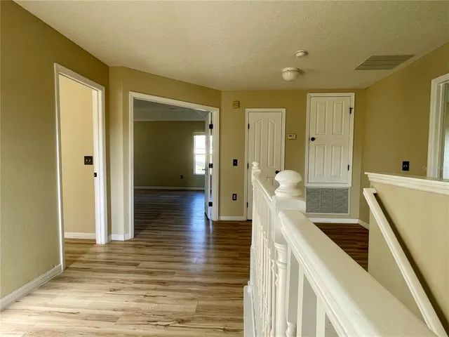 a view of a bathroom with mirror and shower