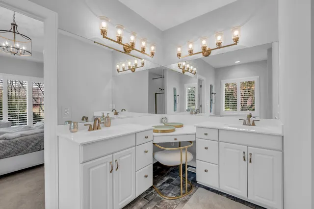 a spacious bathroom with a sink a large mirror and a vanity